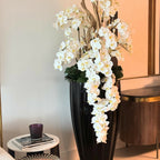 San Jose Vase in glossy black with hanging yellow orchids