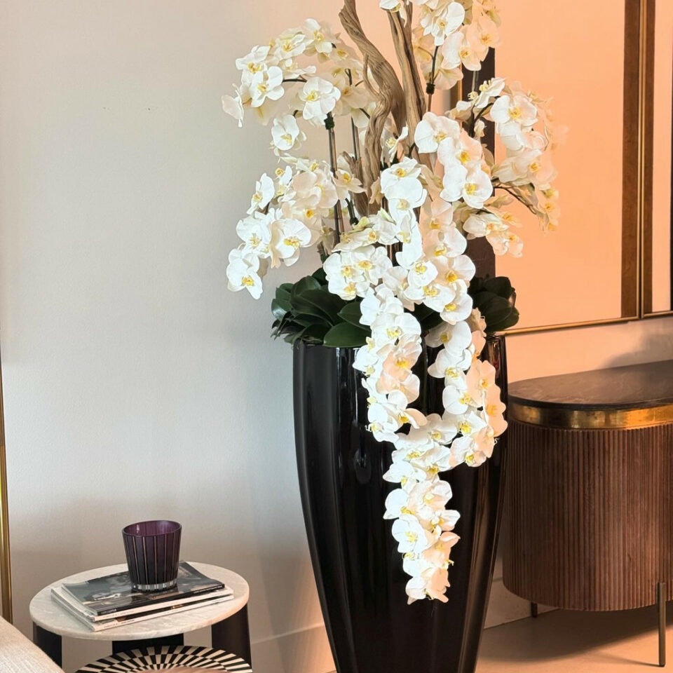 San Jose Vase in glossy black with hanging yellow orchids